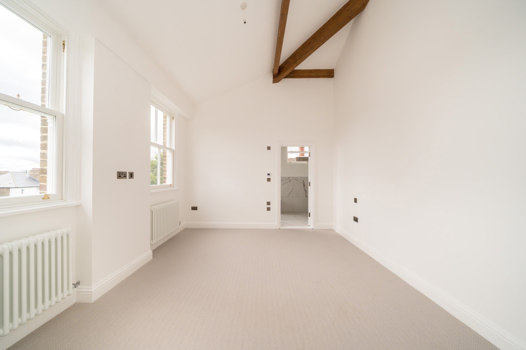 COMPLETED · Upper room with exposed timber truss, July 2026